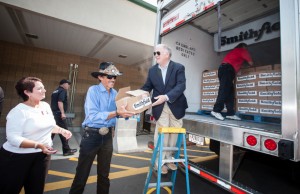 Dennis Pittman, Senior Director or Corporate Communications for Smithfield, Racing Legend Richard Petty & volunteers line up to unload a portion of the 40,000 pound protein donation from Smithfield's Helping Hungry Homes