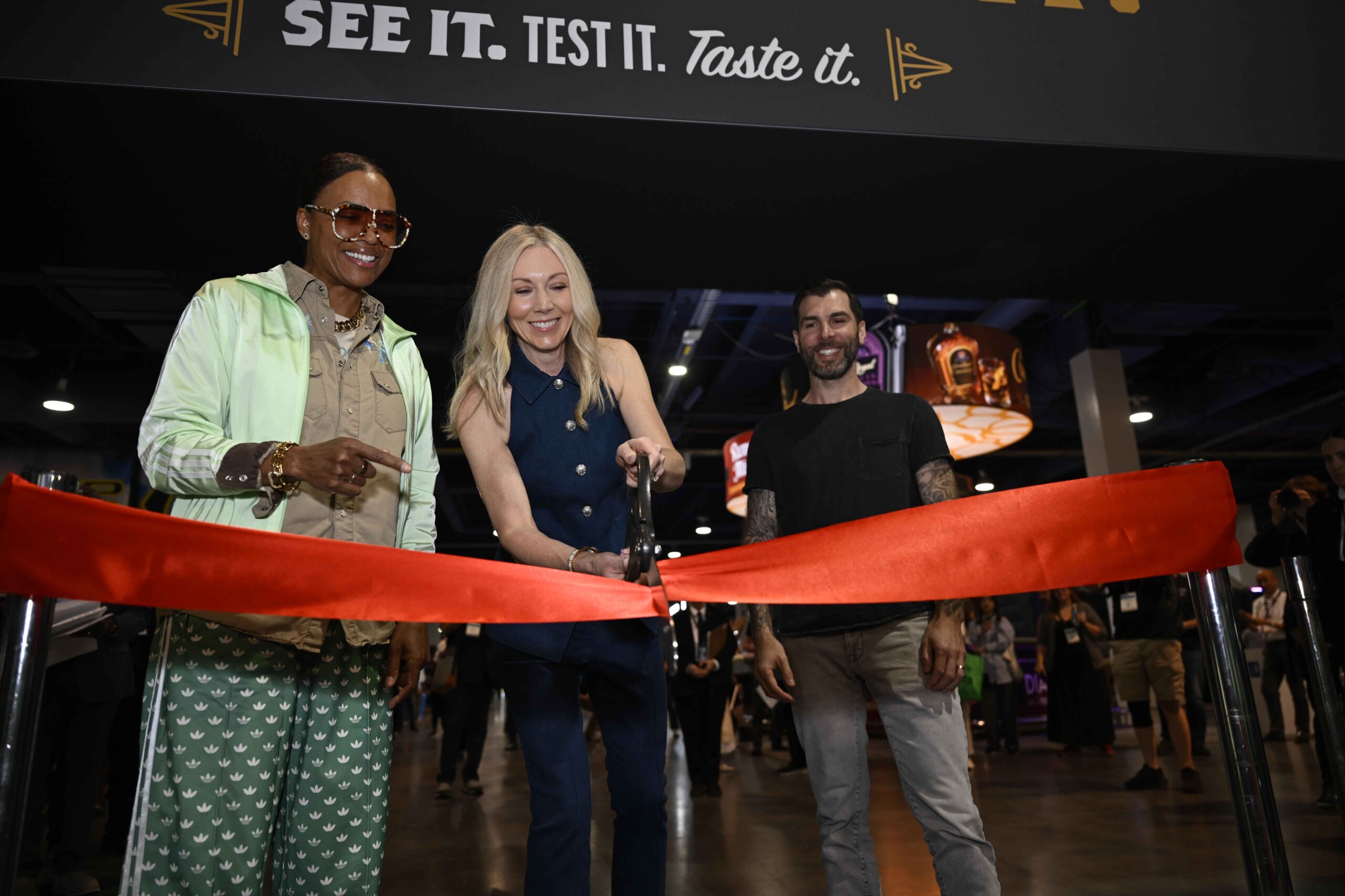L-R Aisha Tyler, Brandy Rand, Mike Cessario cutting ribbon at 2026 Bar & Restaurant Expo